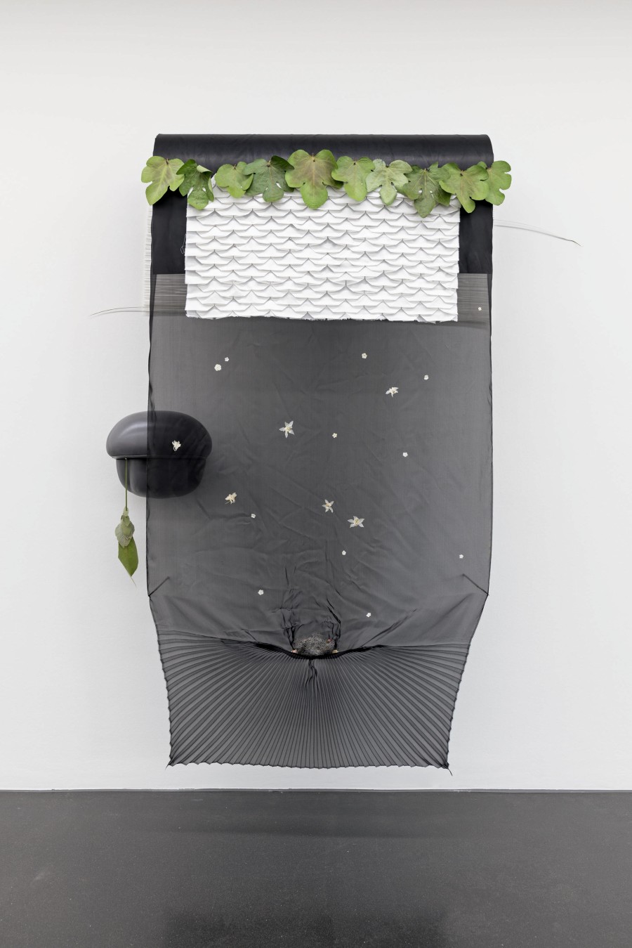 Maude Léonard-Contant, Cattails, 2023, fig leaves, horsehair, leather, mag- nets, mullein leaves, narrowleaf cat- tail stalks, pimbina petals, pleated organza, pleated raw silk, pleated silk taffeta, poppy flower bud, porcupine quills, soap weed flowers, wood buttercup, organza, pleated cotton, steel, wood, leather. Photo: Marc Latzel