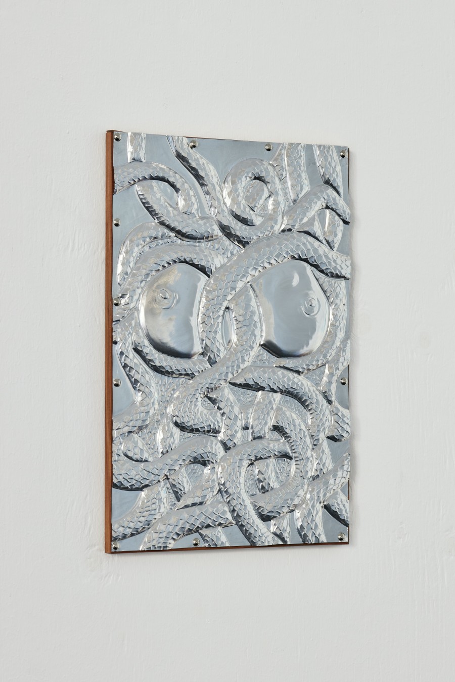 Paula Santomé, Ecdysis, 2023. Handmade aluminium embossing, apple tree wood. 30 x 20 cm. Unique. Photographer: Moritz Schermbach. Courtesy of the artist and VITRINE London/Basel.