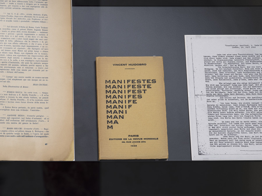 Exhibition view «Poetry for Revolutions», Cabaret Voltaire 2023; Dada showcase with changing exhibits from the collection of the Kunsthaus Zürich: Magazine Procellaria, number 5, 1920, Mantova, pp.66-67; Vincent Huidobro, Manifestes, Manifeste, Manifest, Manifest, Manifeste, Manif, Mani, Man Ma, M, 1925, Paris; Hugo Ball, Eröffnungs-Manifest (Opening Manifesto), 1916, Zurich (facsimile). Photo: Cedric Mussano.