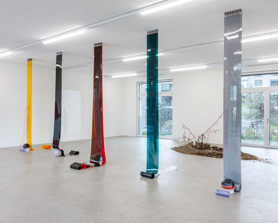 Exhibition view “Our Labor, Our Passion, Our Love”; Charly Mirambeau, Private Pursuits and Public Problems, 2024, stainless steel rail, PVC, glass, fabric (five elements), CALM - Centre d'Art La Meute, Lausanne, Switzerland, 2024 / Photo: Théo Dufloo / Courtesy of the artist and CALM - Centre d'Art La Meute.
