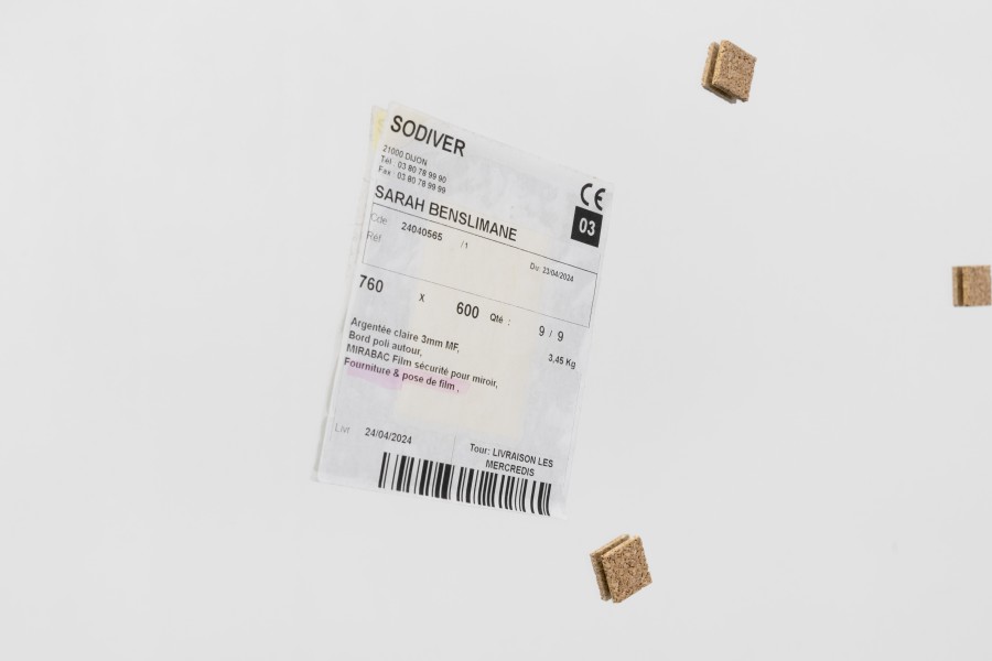 Sarah Benslimane, Untitled (detail), 2025, Mirror, transport etiquette, cork, 60 × 76 × 1 cm. Photo credits: marytwo