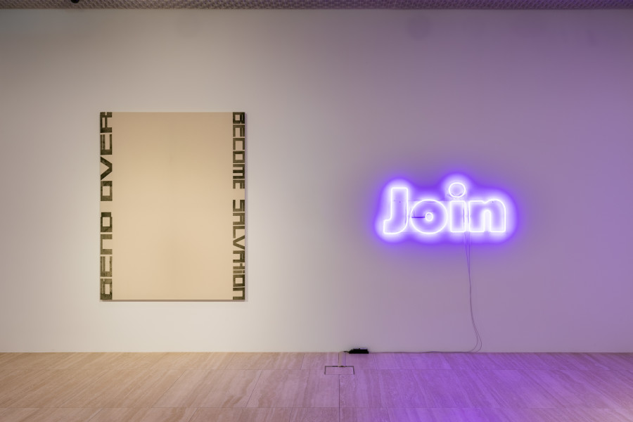 Left: Marlene McCarty, Untitled (Bend Over Become Salvation), 1993, Heat Transfer on Canvas, 198 x 152 cm Private collection, Switzerland. Right: Mitchell Anderson, Join (the Great Peace March (Keith Haring, 1986)), 2023, Neon, glass, 55 x 130 cm. Photo: Kilian Bannwart