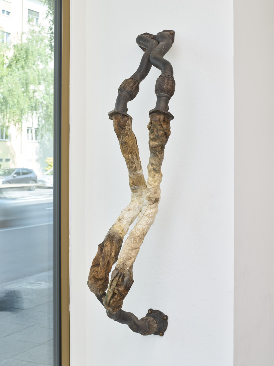 Mónica Mays, Lub permeates wall I, 2025, Found exhaust system, vellum, wax, 145 x 28 x 47 cm. Blue Velvet, Zurich, Switzerland, 2025, Photo: Felix Jungo