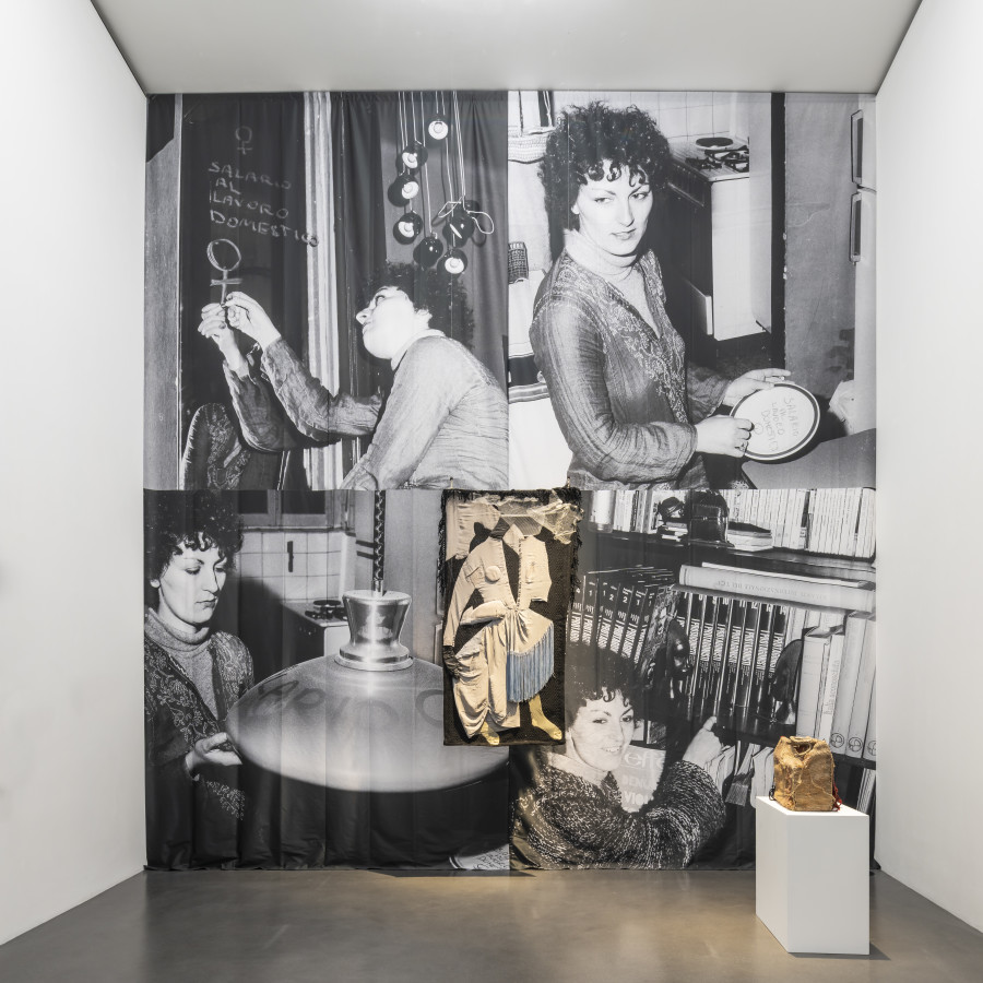 Photography installation by Milli Gandini, Mom Has Gone Out: A Salary for Housework (La mamma è uscita. Salario al lavoro domestico) 1975, vintage photography, pictured is Mirella Tognola, (c) and courtesy of Manuela Gandini. Artwork in the centre (patchwork of clothes) by Mariuccia Secol, The Doll's House. Wedding dress (Casa di bambola. Abito di sposa), 1970, © Muzeum Susch / Art Stations Foundation; photograph: Federico Sette.