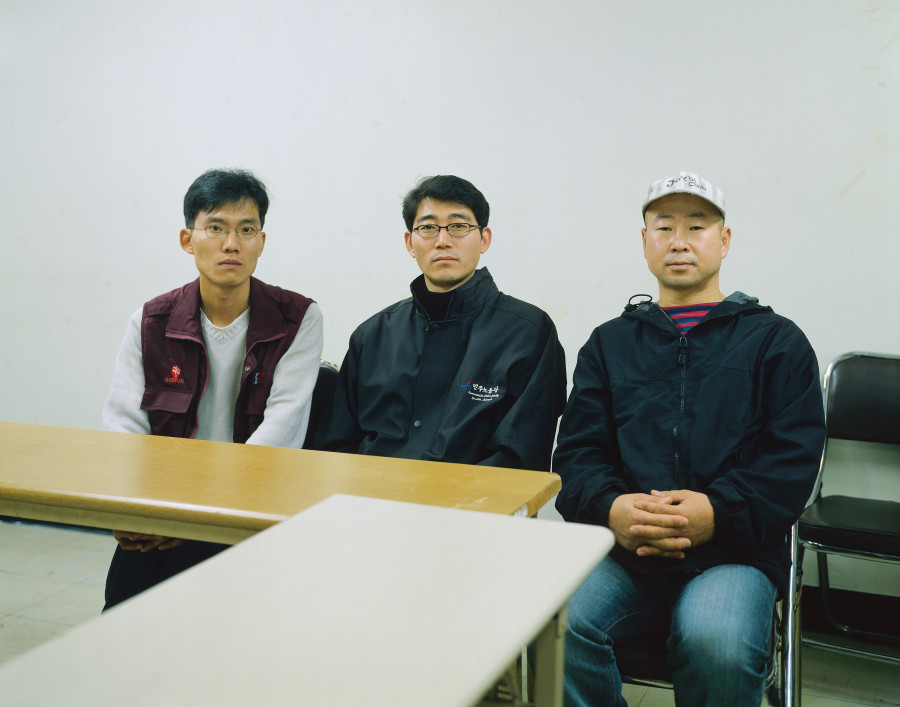 Park Jun Kyu, Hwang Yi Min, Yu Man Hyeong (in a meeting room at KCTU headquarters), Seoul, 2001. Framed Ilfochrome print mounted on aluminum, 128 x 159 cm, Ed. 1/3 + 2 AP