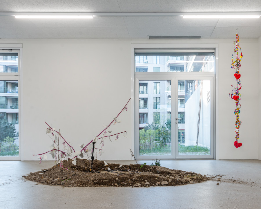 Exhibition view “Our Labor, Our Passion, Our Love”; Juri Bizzotto, Phytolacca Vol. 1, 2024, installation and performance, branches, beads, fabric, microphone, dim. variable, CALM - Centre d'Art La Meute, Lausanne, Switzerland, 2024 / Photo: Théo Dufloo / Courtesy of the artistex and CALM - Centre d'Art La Meute.