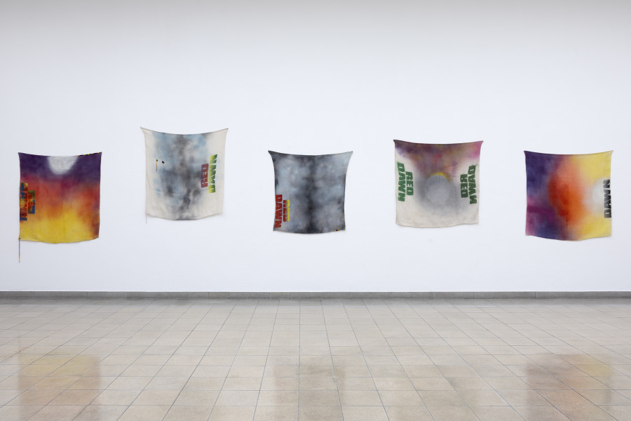 Rochelle Feinstein, The Today Show, installation view, Kunsthaus Glarus, 2025. Photo: Gina Folly. Courtesy the artist, Candice Madey Gallery and Galerie Francesca Pia, Zurich. Red Dawn Sampler, 2022, Dawned/1984, 2022, Dawning, 2024, Double Dawned/2012, 2022, Dawned, 2022, Acrylic, acrylic enamel spray paint on cotton drop cloth, 130 x 130 cm / 51 x 51 in