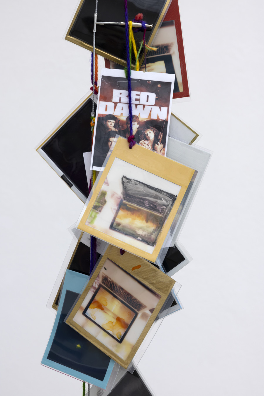 Rochelle Feinstein, The Today Show, installation view, Kunsthaus Glarus, 2025. Photo: Gina Folly. Courtesy the artist and Galerie Francesca Pia, Zurich. Golden Moments Silver Linings 1, 2021–2024, Hand-dyed Yarn, gouache, watercolour on laminated Polaroid film, alligator clips on wire, Height variable, approx. 70 x 5 in